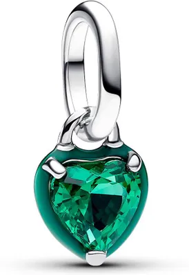 A close-up studio shot of a silver charm with a green heart-shaped gemstone.