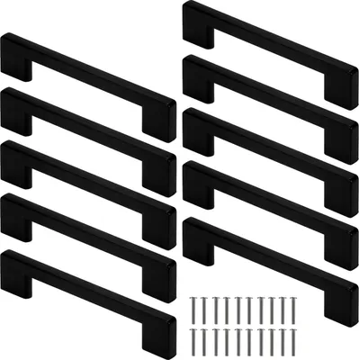 A collection of black cabinet handles and screws arranged on a white background.