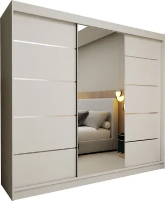 A modern white wardrobe with a mirrored sliding door, reflecting a bedroom scene.