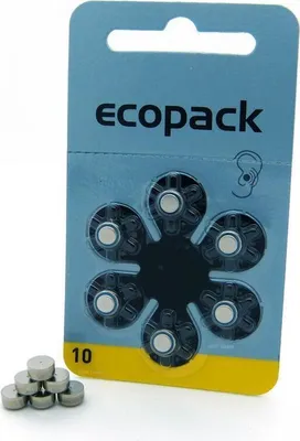 A blister pack of hearing aid batteries with a few loose batteries in the foreground.