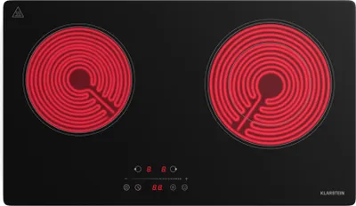 A top-down view of a black electric ceramic stovetop with two red heating elements.