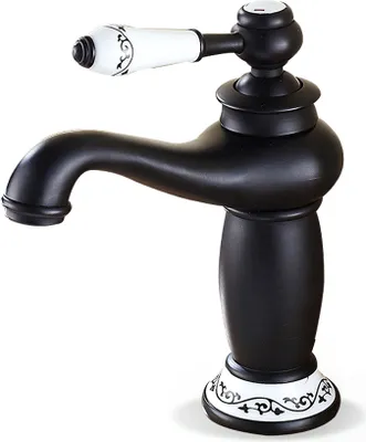 A black faucet with white ceramic accents and decorative patterns.