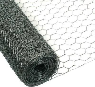 A roll of hexagonal wire mesh, also known as chicken wire, is shown on a white background. The mesh is dark gray and appears to be galvanized.