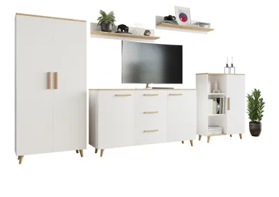 A set of modern white living room furniture with wood accents, including a tall cabinet, a media console with drawers and cabinets, and a smaller cabinet with shelves. Two shelves are mounted on the wall above the media console, displaying decorative items