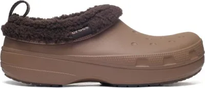A single brown Crocs shoe with a fuzzy brown lining is shown against a white background.