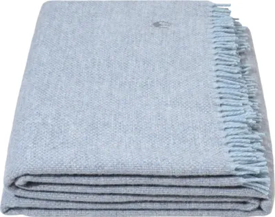 A folded light blue blanket with fringes on a white background.