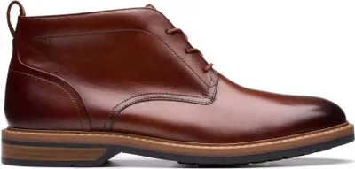 A side view of a brown leather chukka boot.