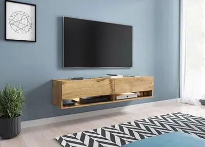A modern living room with a wall-mounted TV and entertainment unit.
