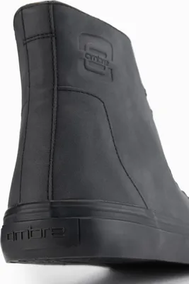 A close-up, rear view of a black boot.