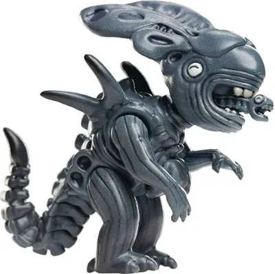 A toy figurine of a creature with a distinctive head crest and a smaller creature emerging from its mouth.