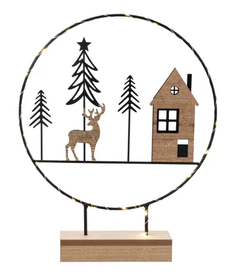 A decorative Christmas scene with a house, trees, and a deer, illuminated by LED lights.