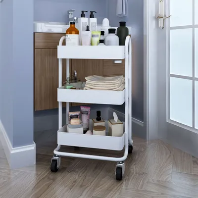 A white rolling cart filled with bathroom products is shown in a bathroom setting.