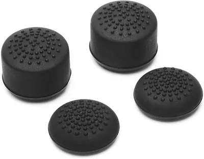 Four black thumb grips for a game controller are arranged on a white background.