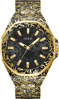 A close-up, studio shot of a gold and black patterned Guess watch against a white background.