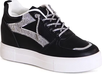 A studio shot of a single black wedge sneaker with silver glitter accents.