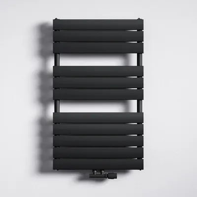A black radiator mounted on a white wall.