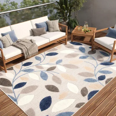 An outdoor patio setting with furniture and a rug.