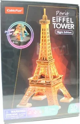 The image shows the packaging of a 3D puzzle of the Eiffel Tower, specifically the "Night Edition".