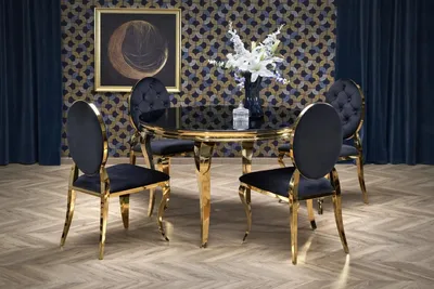A dining set with a round glass table and four chairs in a luxurious room setting.