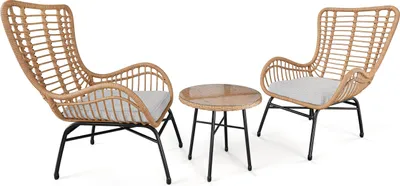 A set of two wicker chairs and a small round table, presented on a white background.