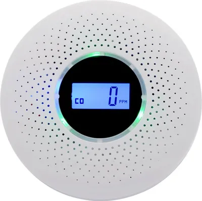 A white, circular carbon monoxide detector with a digital display.