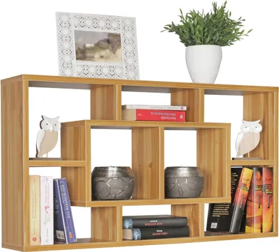 A wooden wall shelf filled with decorative items and books.