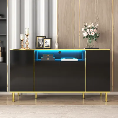 A black sideboard with gold trim and LED lighting, decorated with framed pictures, candle holders, and a vase of flowers.