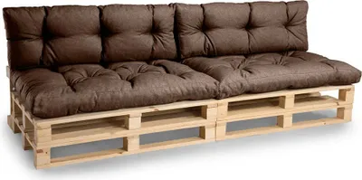 A brown sofa made of wooden pallets with cushions.