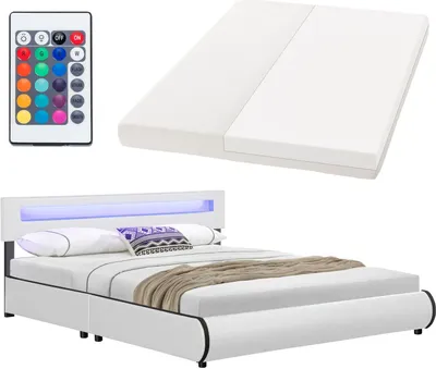 A white bed frame with a mattress, pillows, and a throw blanket, along with a remote control for LED lighting.
