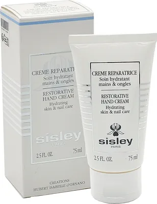 A product shot of a hand cream tube and its packaging.