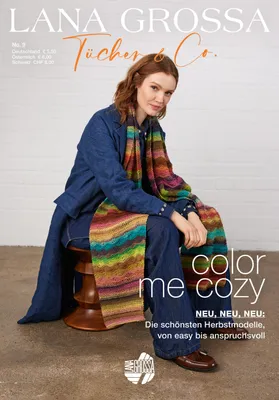 A woman is sitting on a stool, wearing a denim jacket and jeans, and a colorful knitted scarf. The background is a plain white wall with some light gray texture.