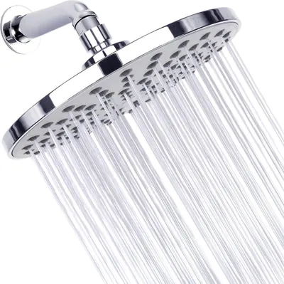 A close-up shot of a chrome shower head with water spraying from it.