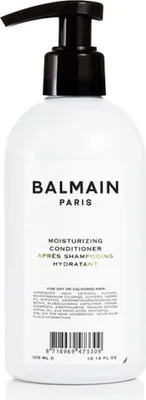 A white bottle of Balmain Paris Moisturizing Conditioner with a black pump dispenser.