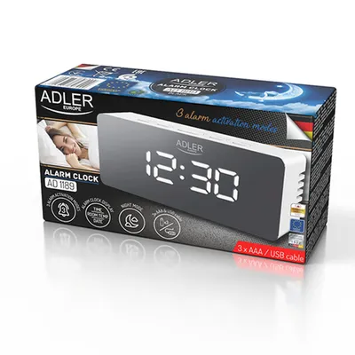 The image shows the packaging of an Adler alarm clock. The packaging features a picture of the alarm clock itself, along with marketing text and icons.