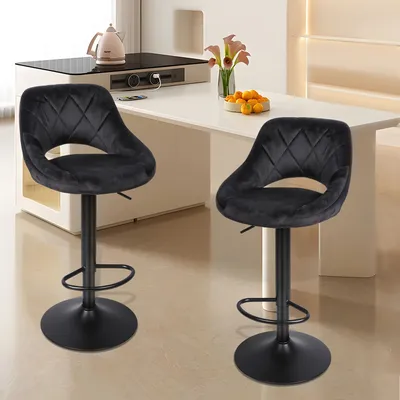 Two black velvet bar stools are shown in a modern kitchen or dining area.