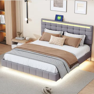 A modern bedroom with a grey upholstered bed featuring LED lighting.