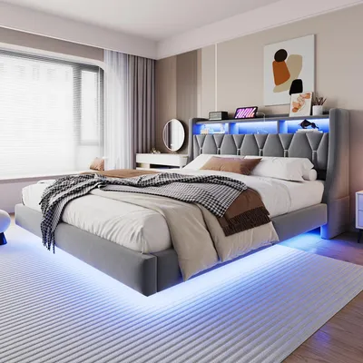 A modern bedroom with a bed featuring LED lighting.