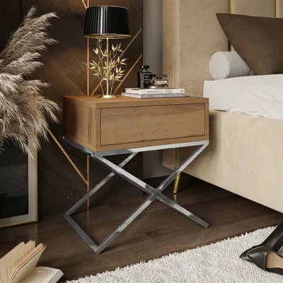 A nightstand next to a bed in a bedroom.