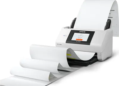 A white Epson document scanner with a long roll of paper feeding out of it.