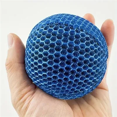 A hand holding a blue, honeycomb-patterned ball.