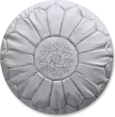 A white leather pouf with decorative stitching and a central star pattern.