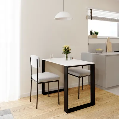 A small dining table with two chairs in a modern kitchen setting.