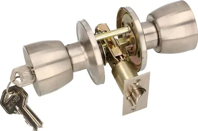 A disassembled door knob lock mechanism with keys on a white background.