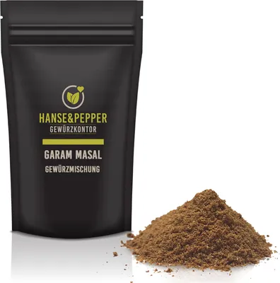 A black pouch of Garam Masala spice mix is shown next to a pile of the spice.