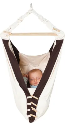 A baby sleeping in a hanging hammock.