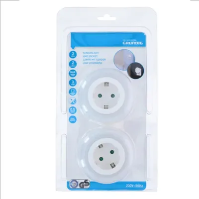 The image shows the retail packaging of two Grundig LED night lights with sensors and sockets.
