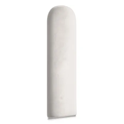 A single, oval-shaped, white padded panel, likely a wall panel or headboard cushion, is presented against a plain white background. The lighting is even, showcasing the texture of the material.