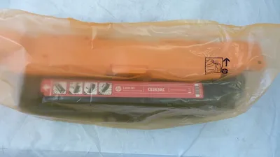 A toner cartridge inside its packaging.