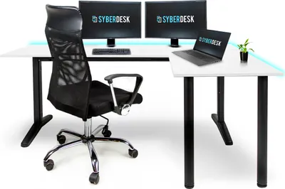 A gaming desk setup with two monitors, a laptop, and a chair.