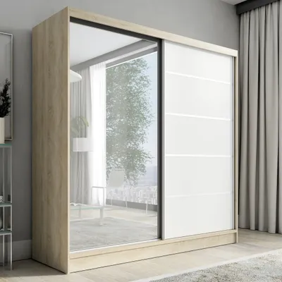 A modern wardrobe with sliding doors, one of which is mirrored, in a room setting.